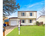 Charming two-story home with manicured lawn, attached garage, and inviting curb appeal at 10781 Moore St, Westminster, CO 80021