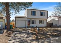 Charming two-story home with attached garage, well-kept lawn, and inviting curb appeal at 10781 Moore St, Westminster, CO 80021