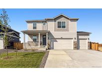 Charming two-story home with a covered front porch and a three-car garage at 4115 Marble Dr, Mead, CO 80504
