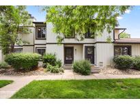Inviting townhome exterior featuring well-maintained landscaping, a walkway, and visible unit numbers at 3695 S Kittredge St # C, Aurora, CO 80013