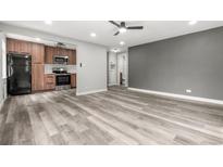 Open-concept living room featuring updated flooring and a ceiling fan at 1182 Clermont St # 201, Denver, CO 80220