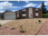Charming two-story home features brick and siding exterior with a two-car garage and low maintenance front yard at 15873 E Hamilton Pl, Aurora, CO 80013