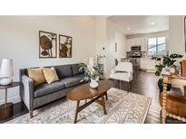 Comfortable living room with modern decor flowing into the dining area and kitchen at 2507 Moline St, Aurora, CO 80010
