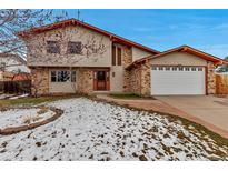 Charming two-story home with a combination of brick and vinyl siding and well-maintained front yard at 85 Yank Way, Lakewood, CO 80228
