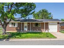 Charming brick home with a well-maintained lawn and an attached one car garage at 11917 Lavinia Way, Northglenn, CO 80233