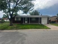 Charming brick ranch-style home with well-manicured lawn and a convenient attached one car garage at 11917 Lavinia Way, Northglenn, CO 80233