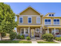 Charming two-story home featuring stone accents, a welcoming porch, and manicured landscaping at 13626 Garfield St # A, Thornton, CO 80602