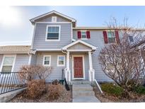 Charming home featuring a covered entrance and red shutters that add character and curb appeal at 5830 Ceylon St # B, Denver, CO 80249