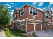 Beautiful multi-story townhouse with stone and siding and two-car garages at 7090 Simms St # 202, Arvada, CO 80004