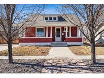 Charming red brick home with a welcoming front porch and well-maintained landscaping at 3133 S Acoma St, Englewood, CO 80110