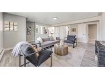 Open living area featuring a comfortable sofa and stylish decor at 6090 W 35Th Ave, Wheat Ridge, CO 80033
