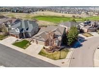 Expansive aerial view of a beautiful home next to a golf course in a desirable neighborhood at 1863 Rose Petal Ct, Castle Rock, CO 80109