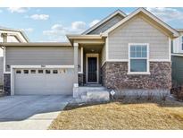Attractive Craftsman style home with stone accents and a two-car garage at 9914 Truckee St, Commerce City, CO 80022