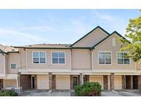 Exterior view of townhomes featuring brick accents and individual garages for each unit at 2154 Concord Ln, Superior, CO 80027