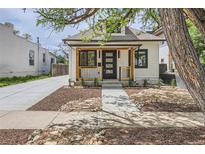 Charming renovated exterior with new siding, front door, landscaping, and sidewalk at 2849 S Bannock St, Englewood, CO 80110