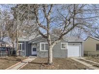 Gray house with white trim, a large tree, and a walkway at 1716 Akron St, Aurora, CO 80010