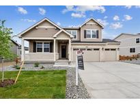 Charming two-story home with landscaped yard, a welcoming porch, and a three-car garage at 7036 E 126Th Pl, Thornton, CO 80602