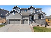 Beautiful two-story home with a three car garage and stone accents at 4009 Manorbrier Cir, Castle Rock, CO 80104