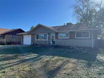 Charming ranch style home featuring a brick facade, cozy porch, and mature trees in the front yard at 841 S 6Th Ave, Brighton, CO 80601