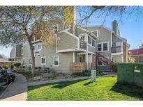 A lovely view of the apartments with lush grass, trees, and a clear, blue sky for a refreshing outdoor experience at 922 S Dearborn Way # 8, Aurora, CO 80012