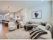 Bright living room boasts modern decor, plush seating, and seamless flow to the open kitchen area at 805 Promenade Dr, Superior, CO 80027