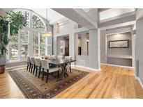 Bright dining room featuring large windows, wood floors, and a modern light fixture at 29432 Camelback Ln, Evergreen, CO 80439