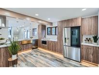 Modern kitchen with stainless steel appliances, wood cabinets, tile flooring and a large basin sink at 375 Aspen Way, Evergreen, CO 80439