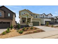 Charming two-story home featuring a manicured front yard and inviting covered porch at 8550 Cheraw St, Littleton, CO 80125