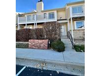 Tan two-story townhome with balcony and landscaping at 956 S Pitkin Ct, Aurora, CO 80017