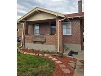 Charming brick home with a cozy front porch and well-maintained landscaping at 2034 S Lincoln St, Denver, CO 80210