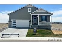 Charming single-Gathering home with a well-manicured lawn, covered entry, and an attached two-car garage at 42982 Colonial Trl, Elizabeth, CO 80107
