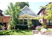 Charming home featuring a well-manicured lawn and inviting front porch at 3410 W 31St Ave, Denver, CO 80211