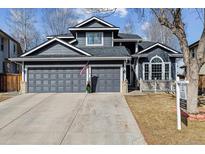 Charming two-story home boasts a three-car garage and well-manicured front yard at 10535 Cottoneaster Way, Parker, CO 80134