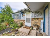 Charming front entrance with brick accents and inviting decor at 17232 E Oberlin Pl, Aurora, CO 80013