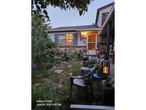 Charming home featuring a landscaped front yard with mature plants and inviting outdoor seating at 17232 E Oberlin Pl, Aurora, CO 80013