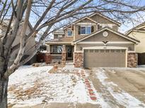 Charming two-story home with well-maintained front yard and attached two-car garage at 487 Oxbow Dr, Brighton, CO 80601