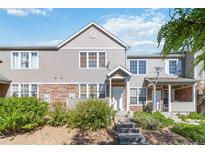 Charming townhome featuring stone accents, neutral siding, and well-maintained landscaping, creating a welcoming curb appeal at 12766 Jasmine St # D, Thornton, CO 80602