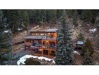 Stunning mountain home featuring multiple decks perfect for enjoying serene views and outdoor living at 6080 Kilimanjaro Dr, Evergreen, CO 80439