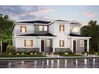Charming two-story home with stone accents and a well-maintained front yard at dusk at 14133 Deertrack Ln, Parker, CO 80134