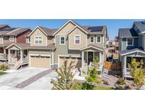 Two-story townhome with modern facade, two-car garage, and landscaped yard at 723 176Th Ave, Broomfield, CO 80023