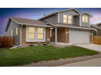 Charming two-story home featuring brick accents, gray siding, a well-manicured lawn, and a two-car garage at 11131 Seton Pl, Westminster, CO 80031