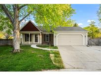 Charming one-story home featuring a well-maintained lawn, attached garage and inviting walkway at 12665 Grove Ct, Broomfield, CO 80020