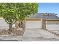 Charming townhome featuring a two-car garage and stone accents at 6727 W Yale Ave, Lakewood, CO 80227