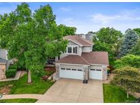 Charming home featuring a three car garage, well-maintained lawn, mature trees and stone accents at 6105 W Long Dr, Littleton, CO 80123
