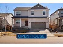 Charming two-story home featuring a brick facade, attached garage, and well-maintained landscaping at 6134 Sugarloaf St, Brighton, CO 80601