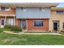 Charming townhome featuring a mix of brick and siding, complemented by a well-maintained front lawn at 8678 Mariposa St, Thornton, CO 80260