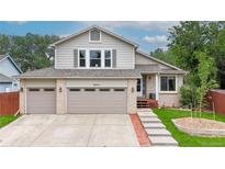 Charming two-story home featuring a well-manicured lawn and a spacious three-car garage at 10517 Clermont Way, Thornton, CO 80233