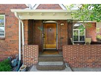 Inviting brick home featuring a charming front door and covered porch area at 1434 Clermont St, Denver, CO 80220