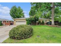 Charming single-story home with well-maintained front yard and attached two-car garage at 5190 W Mexico Ave, Denver, CO 80219