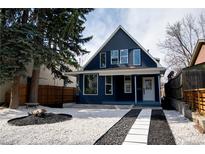 Charming home with dark blue siding, unique landscaping, and bright white trim at 2831 N Perry St St, Denver, CO 80212